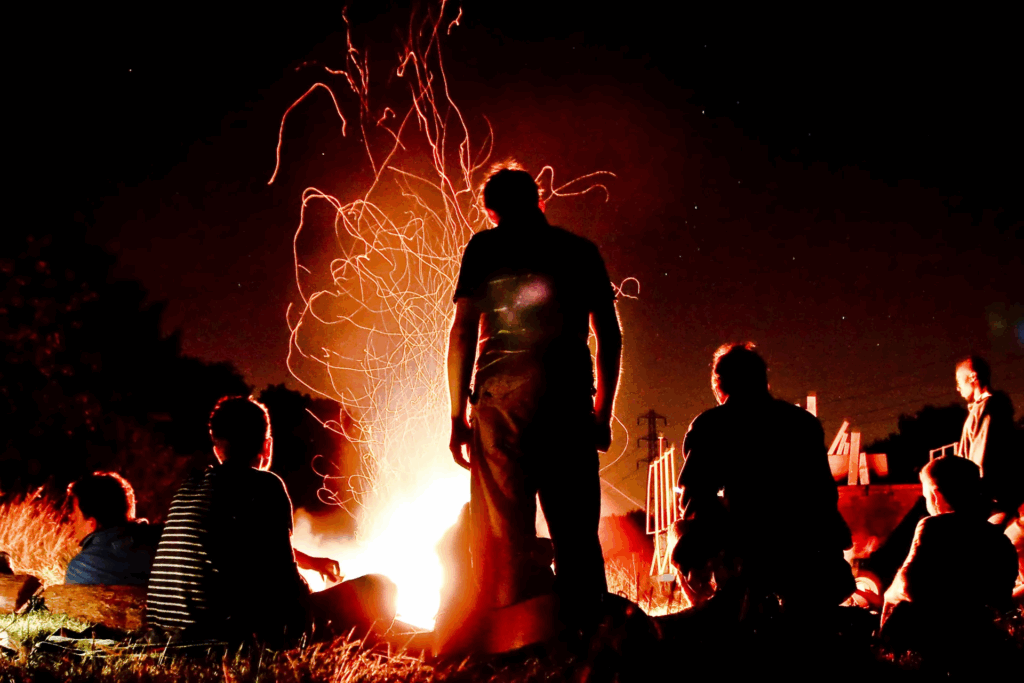 Boys tell stories around a large crackling campfire. Photograph by  Alastair Humphreys.